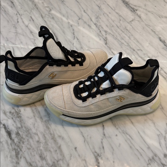 CHANEL Shoes - CHANEL Beige and Black Suede Low-Top Sneakers with Gold CC Accent